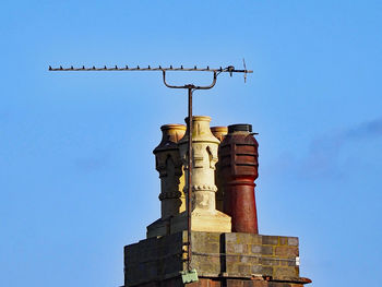 Low angle view of bell tower against blue sky