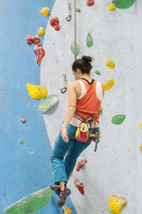 Woman climbing on wall