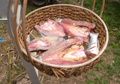 Fresh fish in a basket put to dry in the sun. thai food preservation.