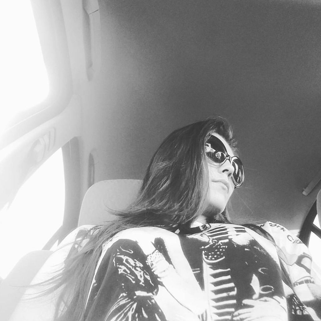 black and white, black, one person, monochrome photography, monochrome, women, white, adult, indoors, glasses, young adult, portrait, lifestyles, mode of transportation, photo shoot, fashion, transportation, vehicle interior, female, sunglasses, headshot, sunlight, hairstyle, leisure activity, person, sitting, long hair, motor vehicle, waist up, car, human face, eyeglasses, looking