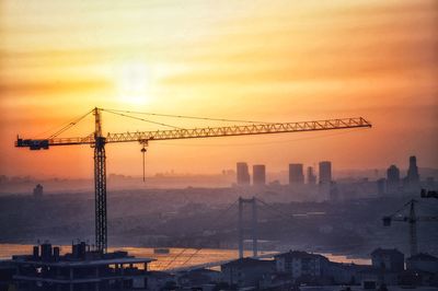 Crane against sky during sunset