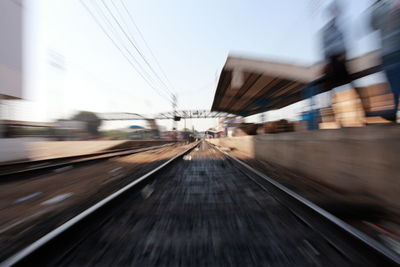 Blurred motion of train at railroad tracks against sky