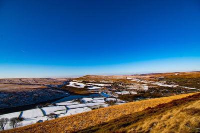 Scenic view of mountains against clear blue sky