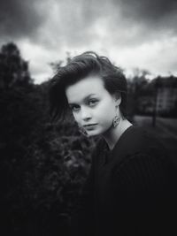 Portrait of young woman standing outdoors