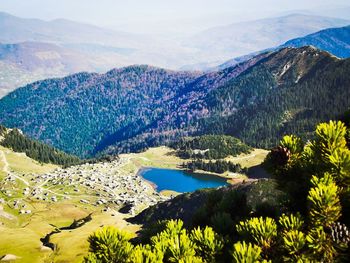 Scenic view of lake and mountains against sky