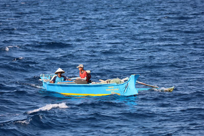 People in boat at sea