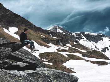 Full length of person on snowcapped mountain against sky