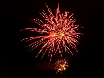 Low angle view of firework display at night