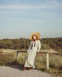 Rear view of woman standing on field