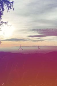 Low angle view of windmill on landscape against sky