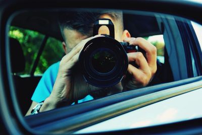 Man taking picture with camera from his car