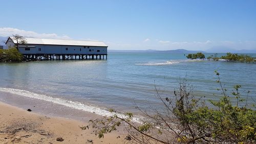 Scenic view of beach by sea against sky