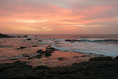 Scenic view of beach against dramatic sky