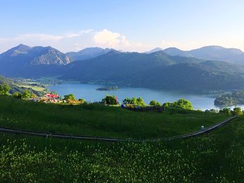 High angle view of lake and mountains against sky