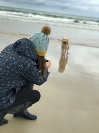 Woman with umbrella on beach