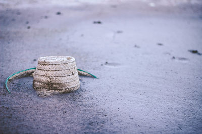 Close-up of rope tied on sand at beach