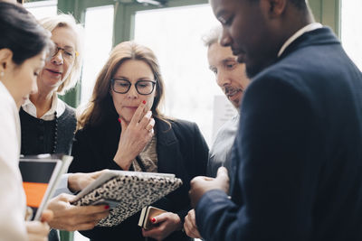 Male and female colleagues looking at file in meeting