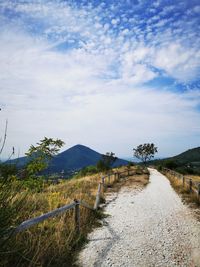 Empty road along countryside landscape