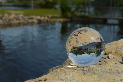 Close-up of crystal ball on rock