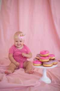 Cute girl holding sweet food at home