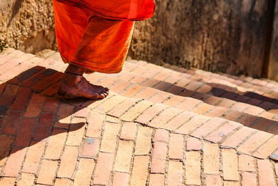 Low section of man standing on street