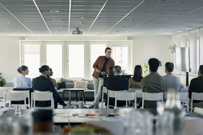 Group of business people attending presentation during conference