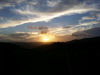 Scenic view of mountains against sky at sunset