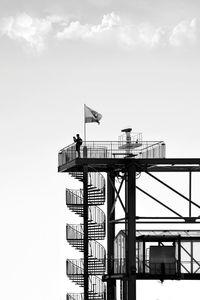 Low angle view of communications tower against sky