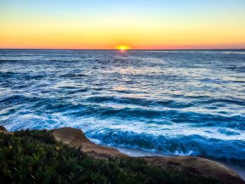 Scenic view of sea against clear sky during sunset