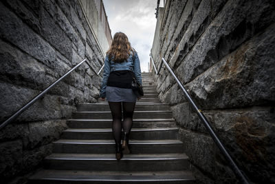 Woman walking on staircase