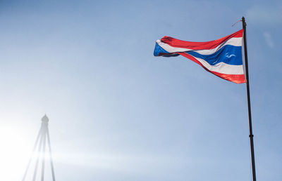 Low angle view of thai flag against clear blue sky