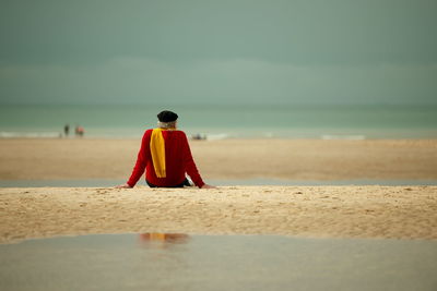 Rear view of man standing at beach