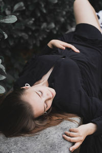 High angle view of woman lying on land by plants