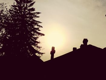 Low angle view of silhouette trees against sky