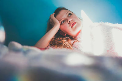 Portrait of young woman lying down