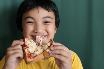 Close-up portrait of boy eating food