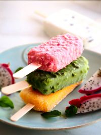 Close-up of popsicles and dragonfruit served in plate