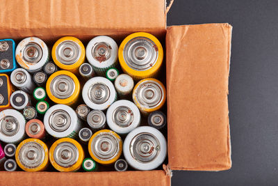 Discharged batteries in cardboard box. collecting used batteries to recycle