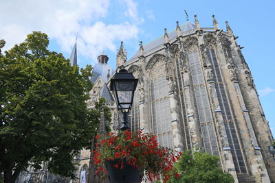 Low angle view of lantern by cathedral against sky