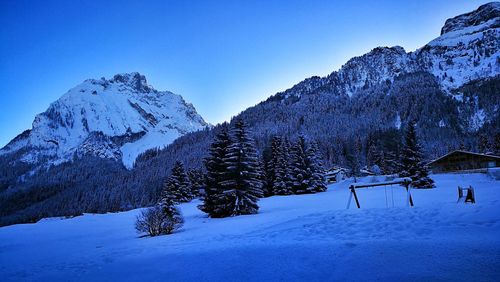 Snowcapped mountains against clear blue sky