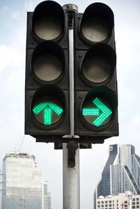 Low angle view of road signal against sky