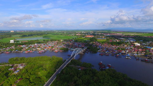 High angle view of river by cityscape against sky