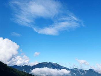 Low angle view of mountains against blue sky