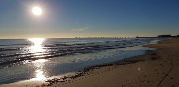 Scenic view of sea against clear sky during sunset