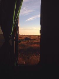 Scenic view of field against sky during sunset