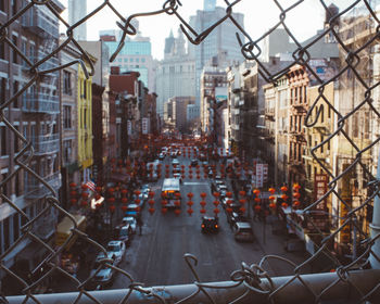 Aerial view of city street seen through chainlink fence