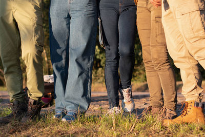 Group of people prepared for a hiking, wearing sturdy shoes and thick trousers for protection ticks