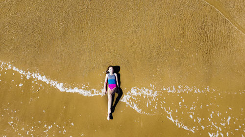 High angle view of woman enjoying at beach