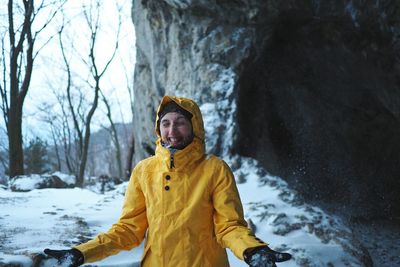 Portrait of young man standing in snow