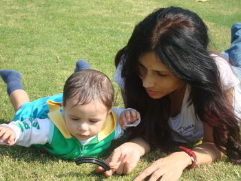 High angle view of mother and son on grass